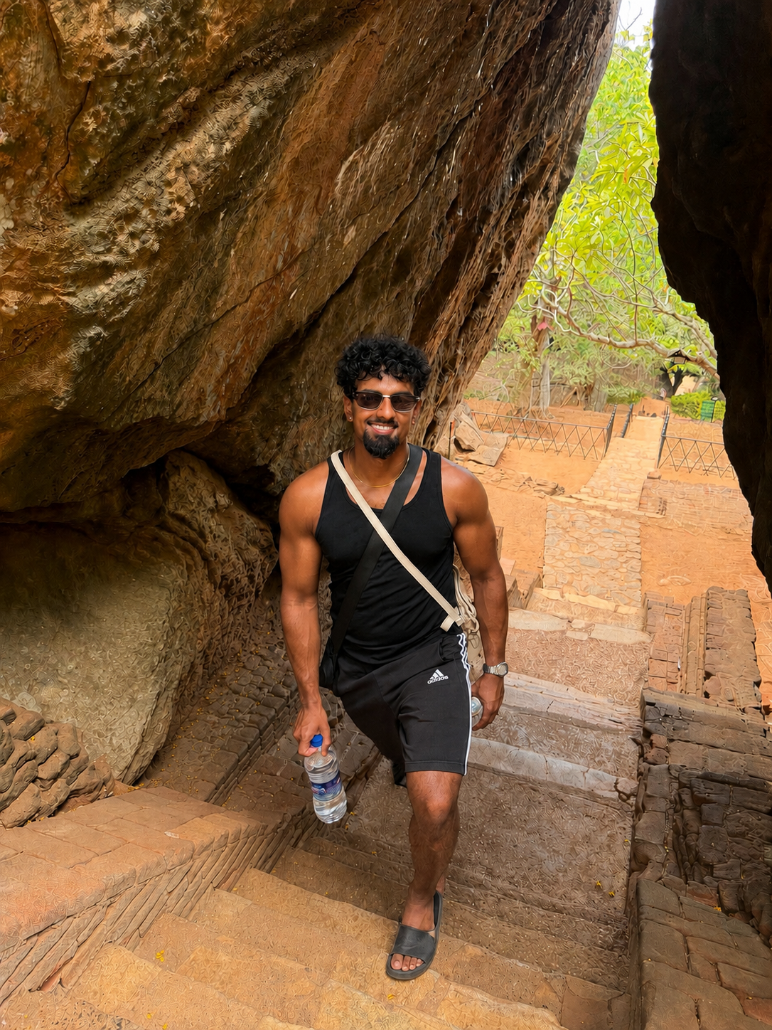 Sanj walking through ancient stone ruins